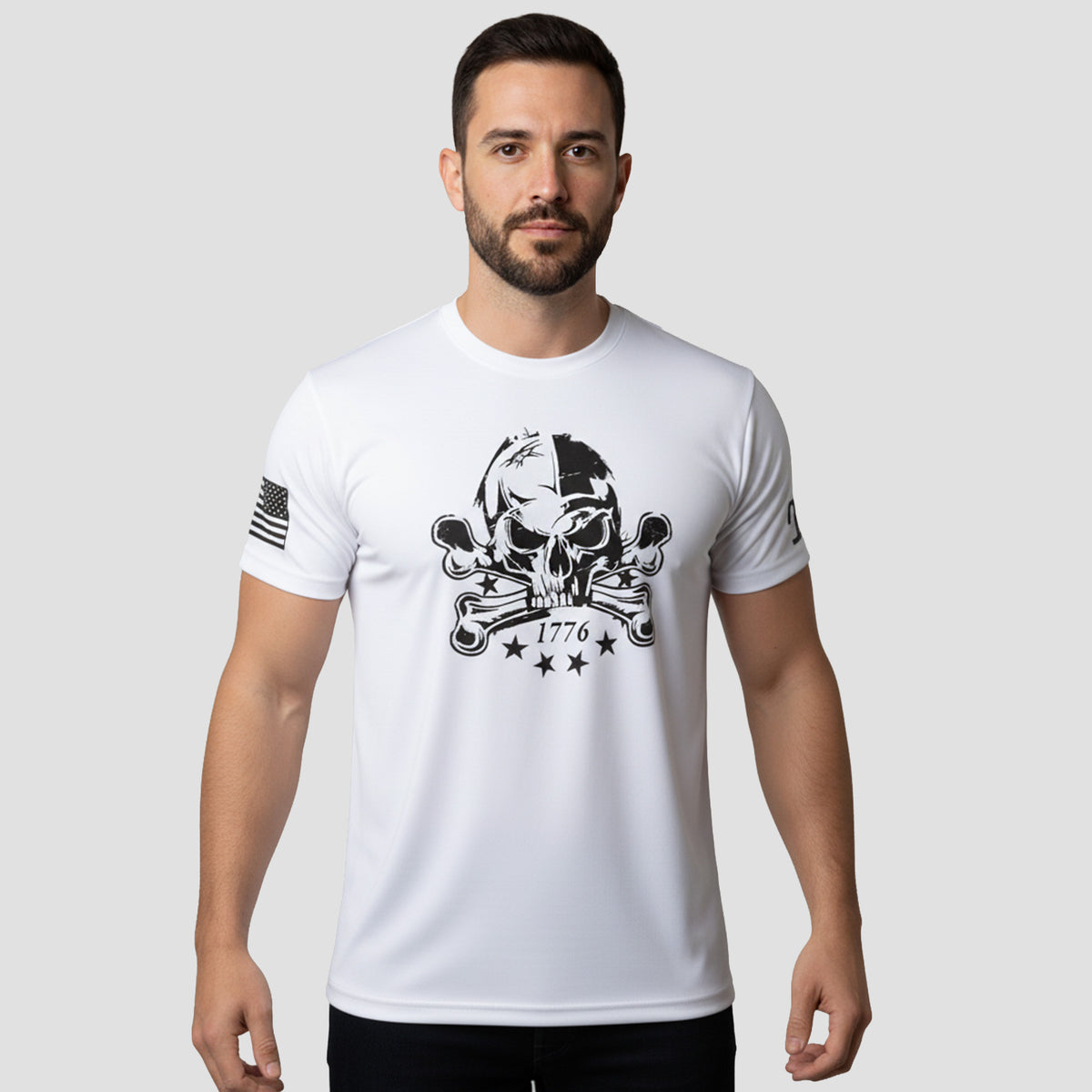 Man wearing a white t-shirt with a black skull and crossbones design on a light gray background