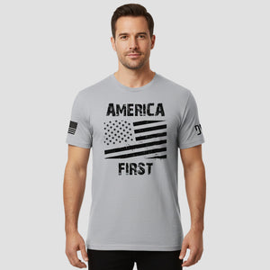 Man wearing a gray t-shirt with 'America First' design on a light gray background