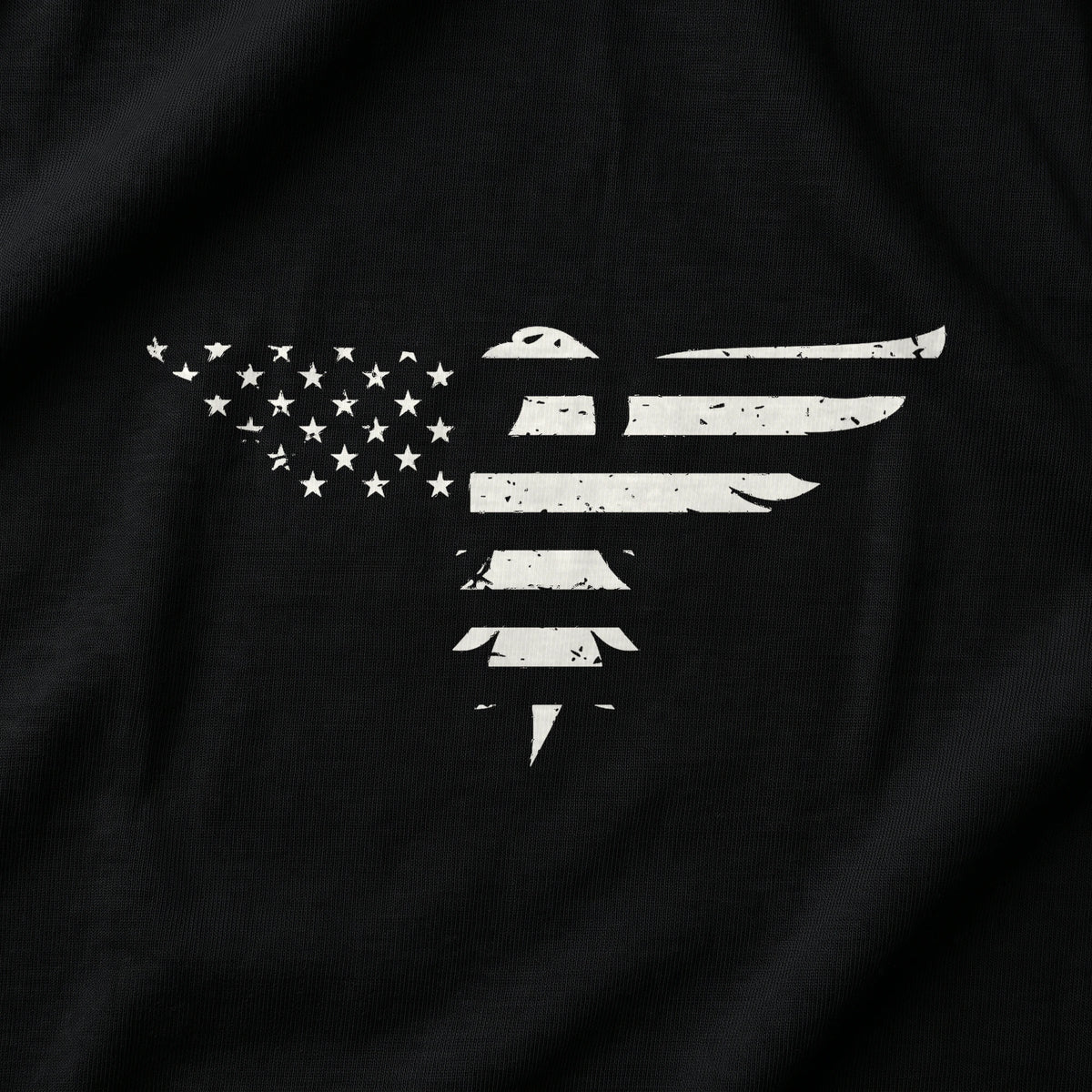 Close-up of the Bald Eagle T-Shirt front print on Black: an eagle built from the stars and stripes, distressed white print (digitally composited print visualization, not a photograph)