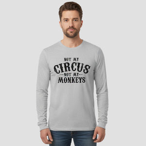 Man wearing a gray long-sleeve shirt with 'Not my circus, not my monkeys' text on a light gray background