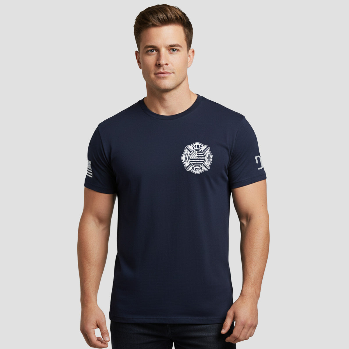 Man wearing a navy blue t-shirt with a logo on a light gray background