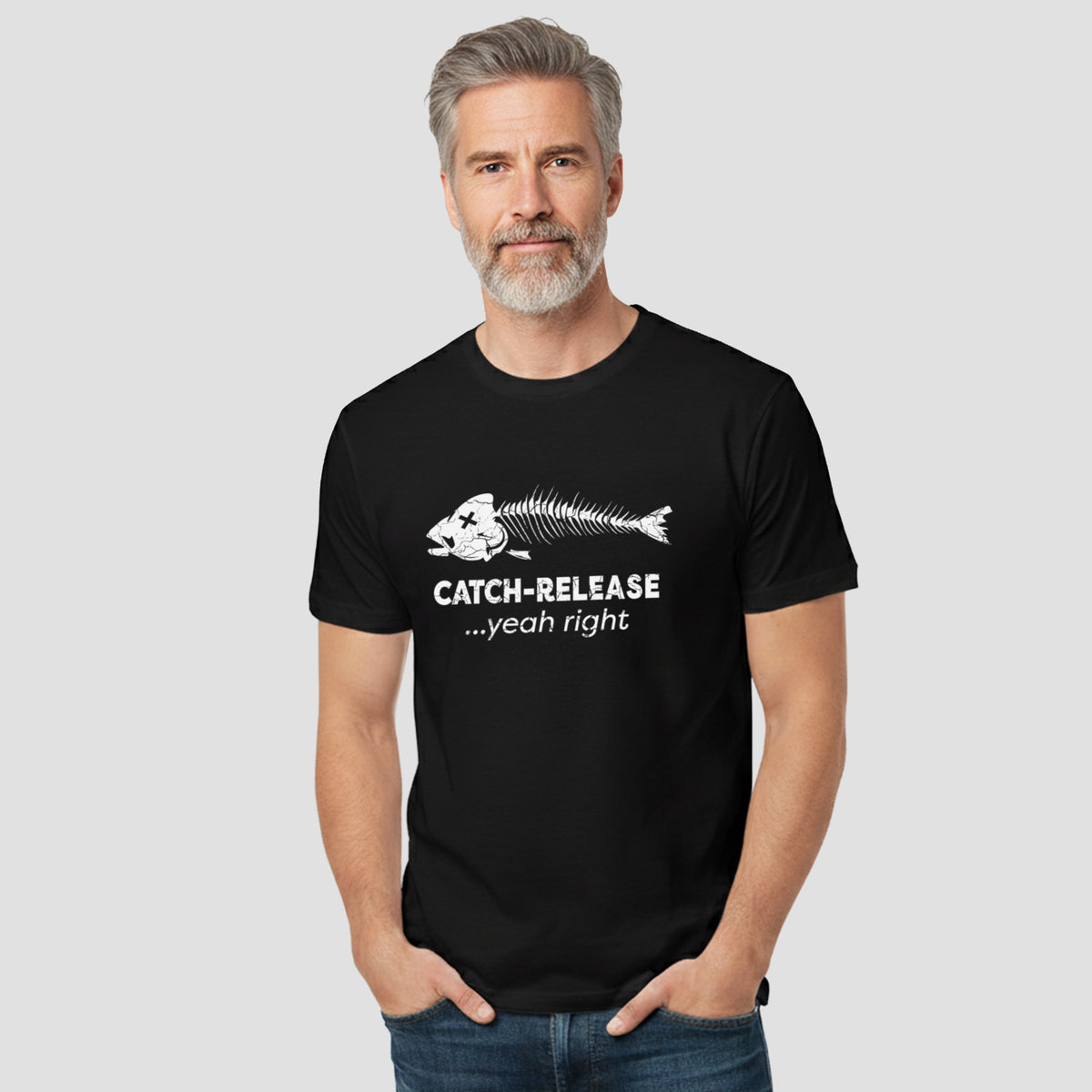 Man wearing a black t-shirt with a fish skeleton design and text on a plain background