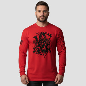 Man wearing a red long-sleeve shirt with black graphic design on a gray background