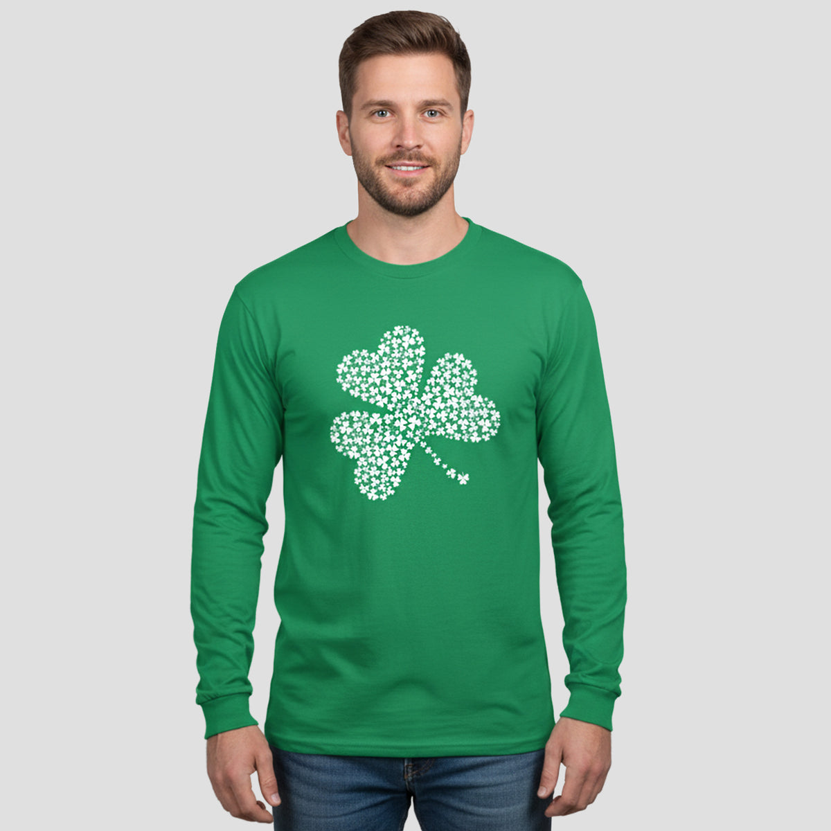 Man wearing a green long-sleeve shirt with a white shamrock design on a light gray background