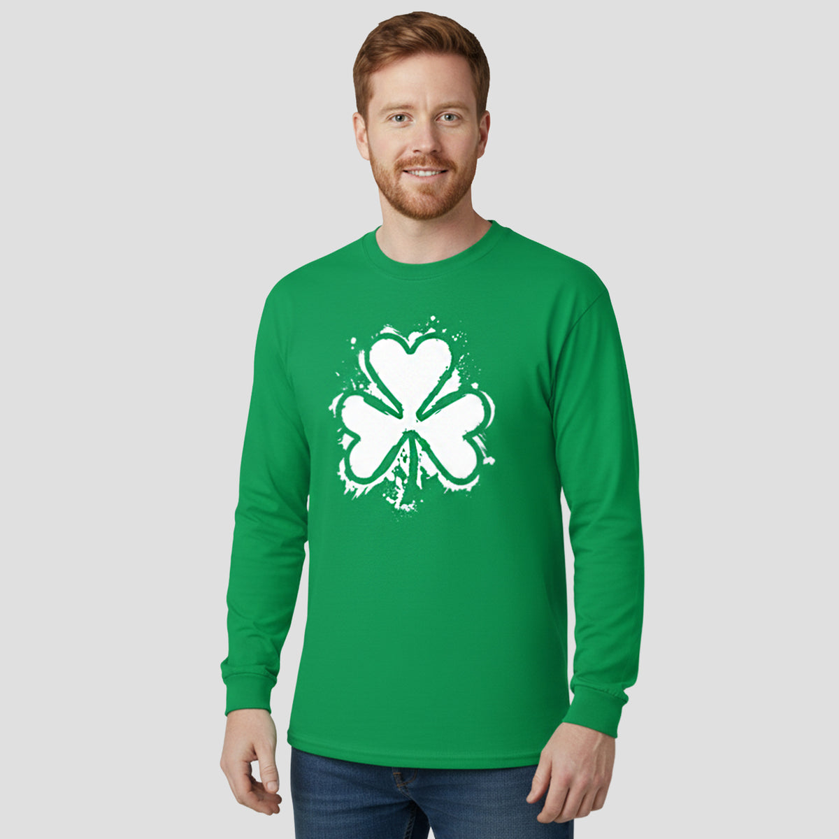 Man wearing a green long-sleeve shirt with a white shamrock design on a light gray background