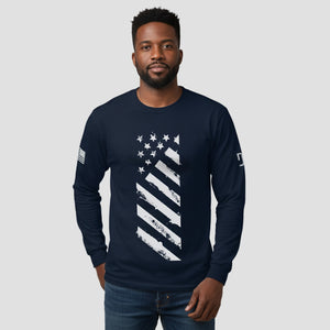 Man wearing a navy long-sleeve shirt with a white flag design on a light gray background