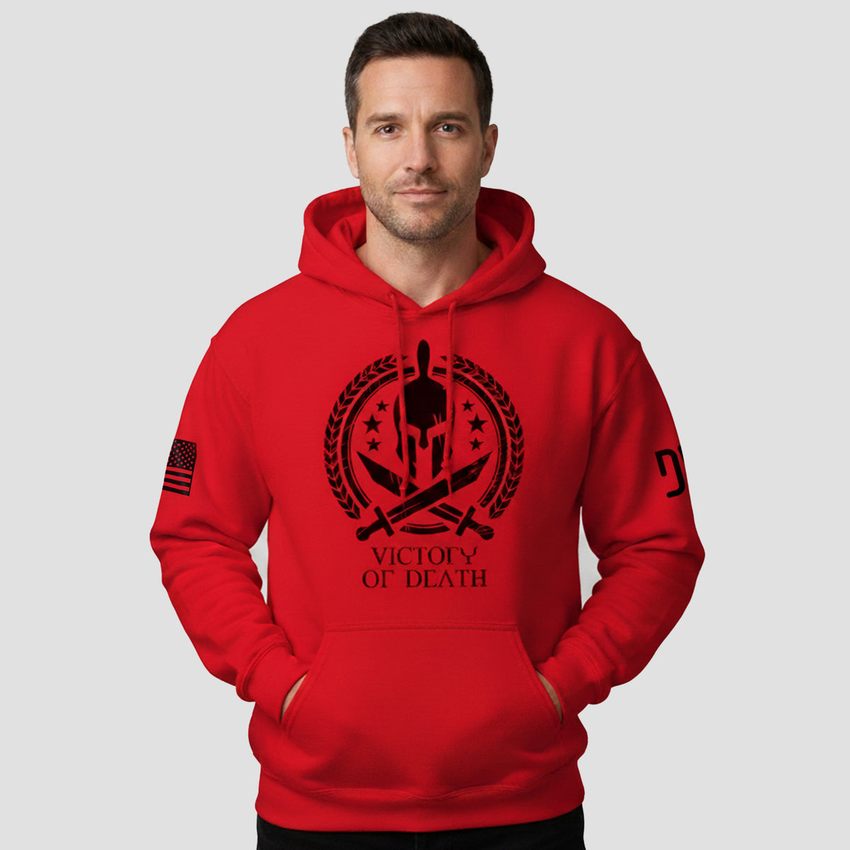 Man wearing a red hoodie with a black graphic design on a gray background