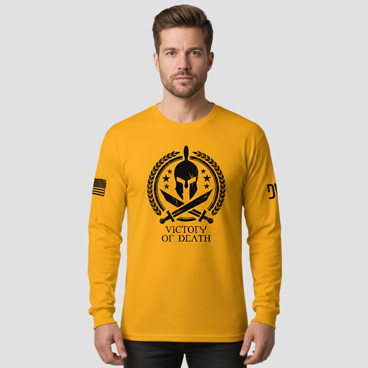 Man wearing a yellow long-sleeve shirt with a graphic design and text on a gray background