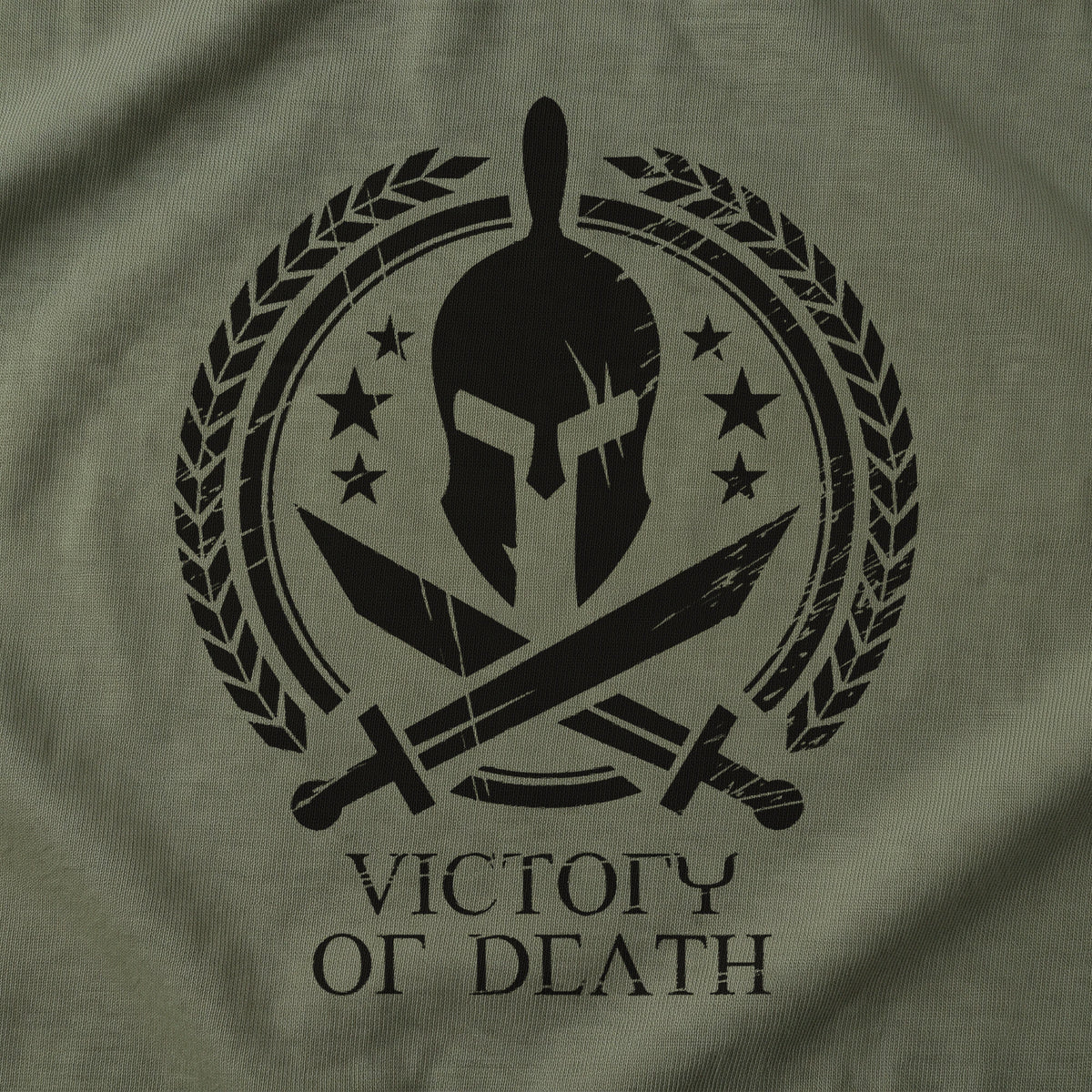 Close-up of the Spartan Warrior T-Shirt front print on Military Green: Spartan helmet in a laurel wreath with stars and crossed swords above VICTORY OR DEATH (digitally composited print visualization, not a photograph)