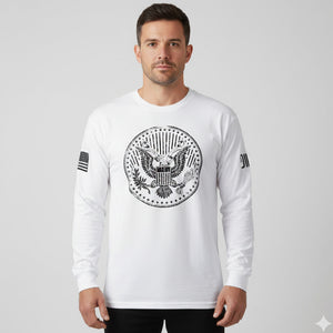 Man wearing a white long-sleeve shirt with an eagle emblem on a gray background