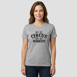 Woman wearing a gray t-shirt with 'Not my circus, not my monkeys' text on a white background