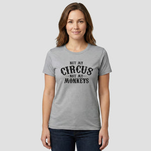 Woman wearing a gray t-shirt with 'Not my circus, not my monkeys' text on a white background